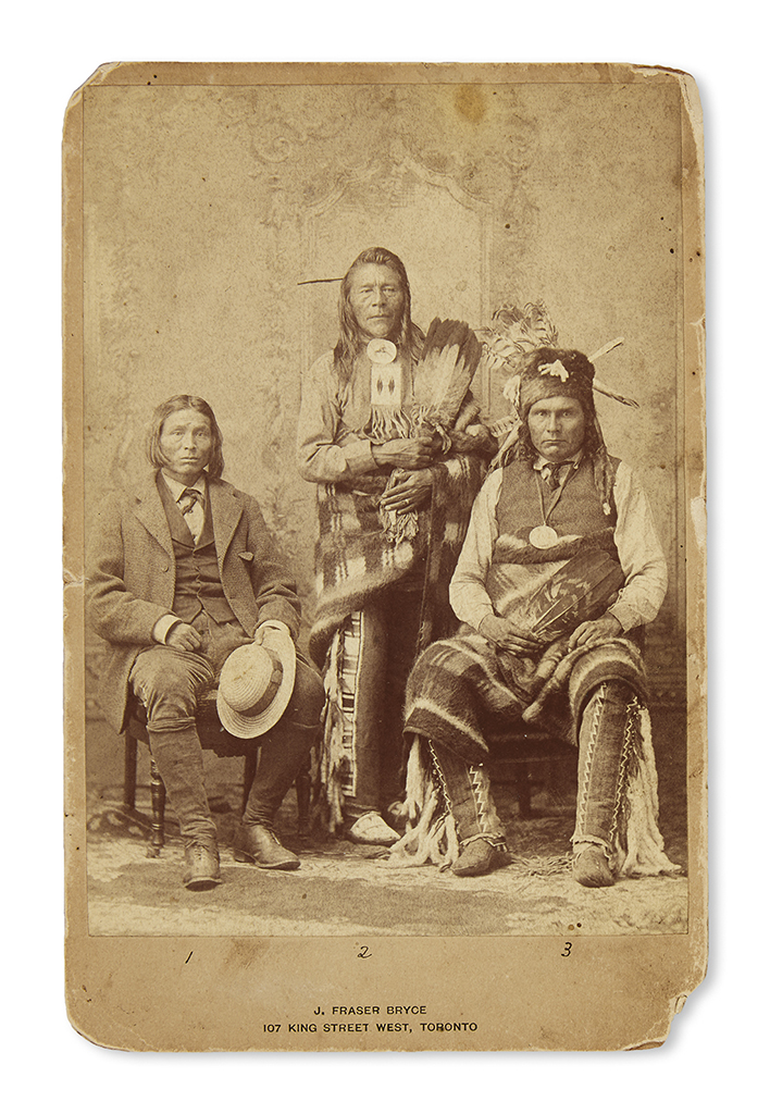 (AMERICAN INDIANS.) Bryce, J. Fraser; photographer. Cabinet card depicting three Cree and Nakoda chiefs in Toronto.